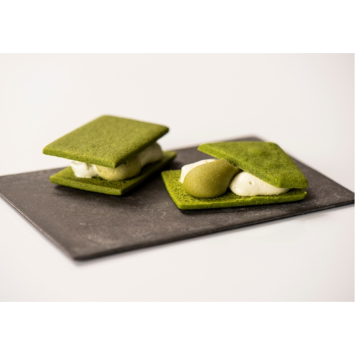 くら吉の抹茶ウィッチという抹茶のタルト生地で抹茶クリームとバタークリームをサンドした商品が黒いお皿に載っている