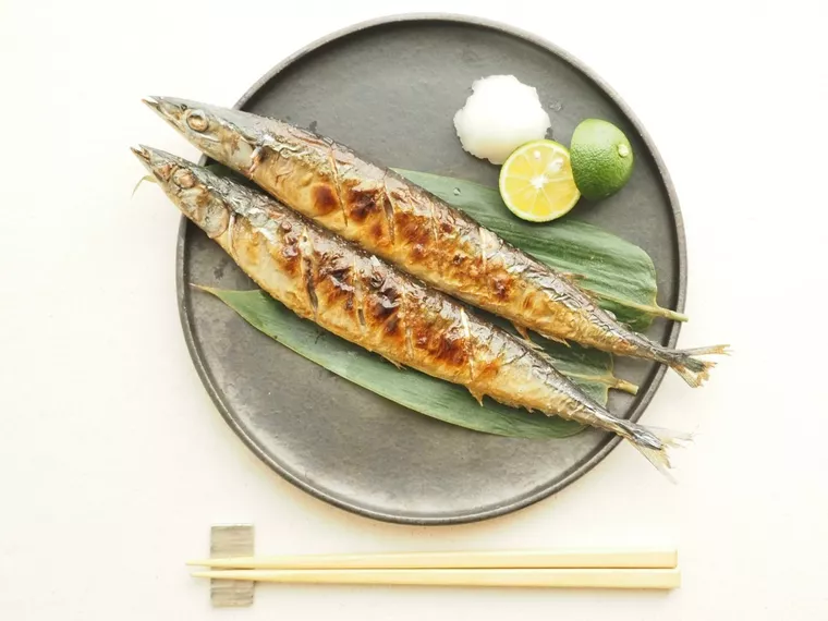 グレーの丸い平皿に盛られたさんまの塩焼き2つ