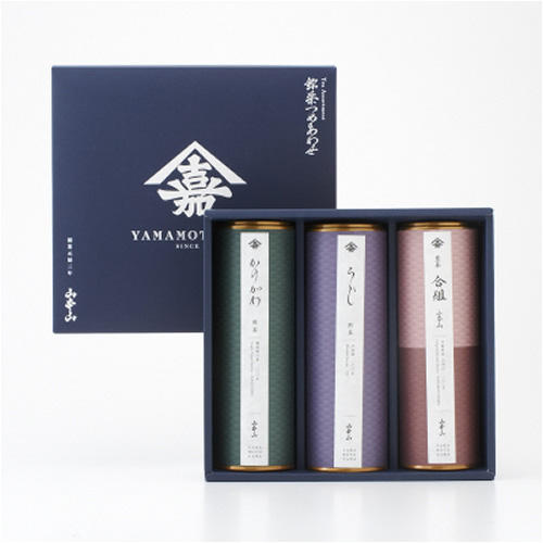 青色の箱に3缶のお茶の葉が入っている。