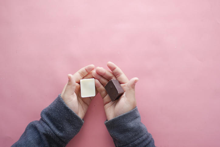 手のひらに包まれたチョコレートとホワイトチョコレート