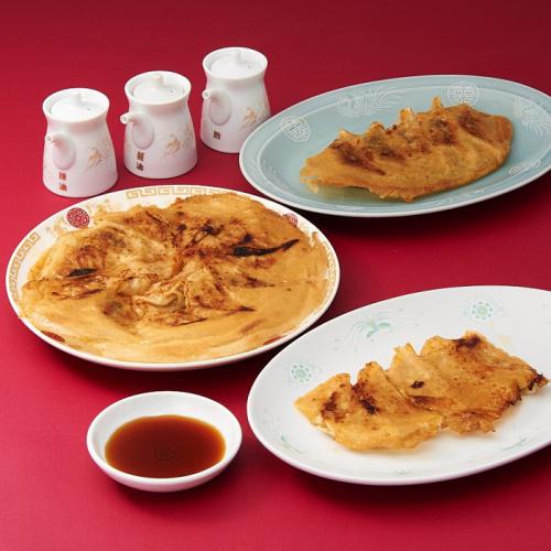 中華皿に盛られた3種類の餃子屋本舗の餃子と小皿に盛られた餃子のタレ