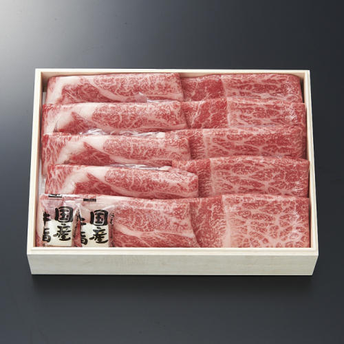 黒色の背景に、すき焼き用の牛肉が入った箱が置かれている。