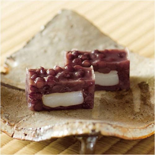 餅に餡子をまとった和菓子がカットされて盛り付けられている