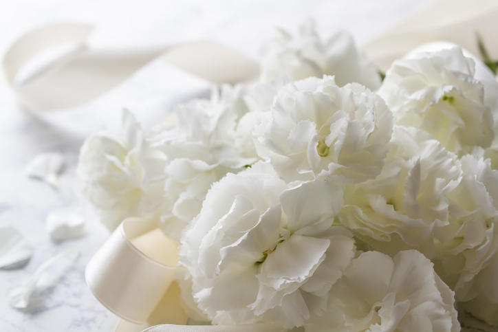 純白の花束と傍らに白いリボン