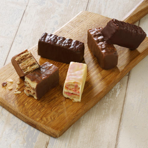 スティックタイプのチョコレートミルフィーユがのった木のまな板が置かれている。