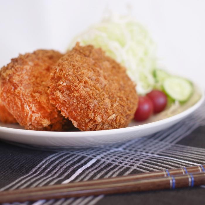 白い皿に盛り付けられた和牛入りコロッケと野菜