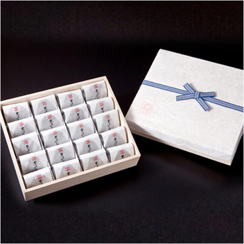 和紙で包まれた小さなお菓子が、木箱に16個詰め込まれている