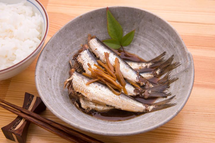 丸い和皿に入ったいわしの煮物