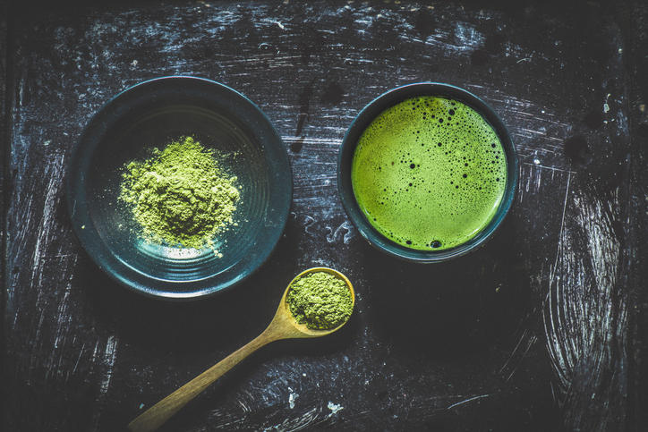 石のテーブルの上に置かれた点てた抹茶と粉末の抹茶