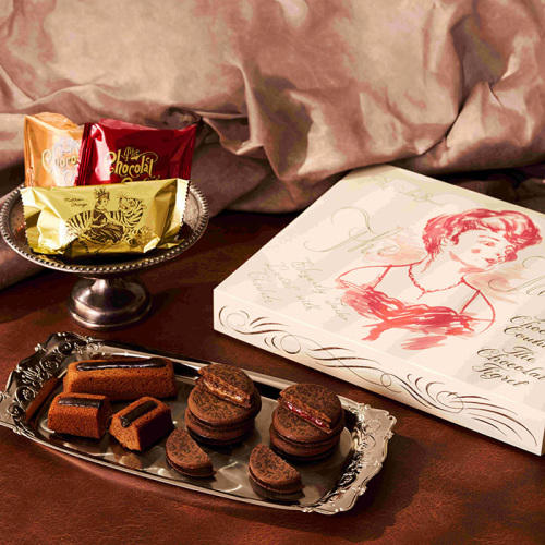 女性のイラストが描かれたギフト箱と皿に盛られたショコラサンド